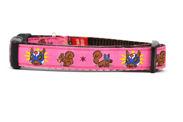 XS pink dog collar - design includes squirrel in lucha libre mask with a yellow flower behind it and a tulip on the mask.  One small squirrel with a tulip in its mough and one with a tulip bulb.  Also, a six pointed star.