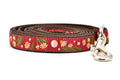Small burgundy dog leash with chamomile flowers, stars, and half moon design.