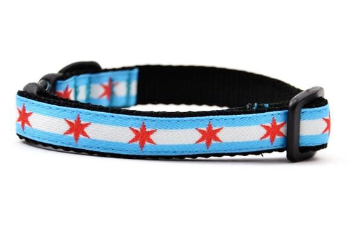 Cat collar with two light blue stripes and one white stripe and red six pointed stars - representing the Chicago Flag.