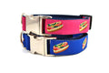 Two stacked collars with metal clasps- one navy and one raspberry with design that depicts the Chicago Style Hot Dog.