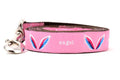 Picture shows pink dog leash with images of angel wings and words earth angel.