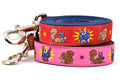 Two dog leashes - one red and one pink - design includes squirrel in lucha libre mask with a yellow flower behind it and a tulip on the mask.  One small squirrel with a tulip in its mouth and one with a tulip bulb.  Also, a six pointed star.
