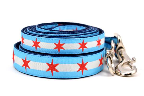Stack of two dog leashes with two light blue stripes and one white stripe and red six pointed stars - representing the Chicago Flag.