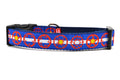 Medium dog collar with light blue and white stripe, red bicycle sprockets - some filled in with yellow.  Emulating the colors of the colorado state flag.