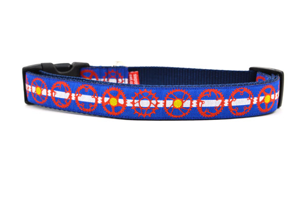 Large dog collar with light blue and white stripe, red bicycle sprockets - some filled in with yellow.  Emulating the colors of the colorado state flag.