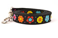 Large black dog leash with daisy chain pattern and colorful daisy flowers.