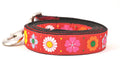 Large red dog leash with daisy chain pattern and colorful daisy flowers.