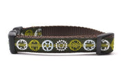 XS green dog collar with light green stripe and bicycyle sprockets in light green, white and light blue.