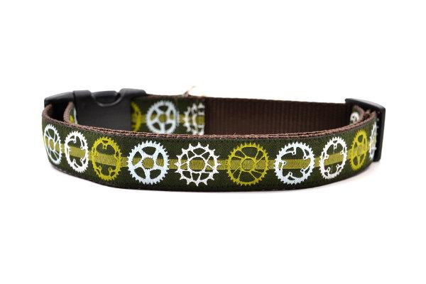 Large green dog collar with light green stripe and bicycyle sprockets in light green, white and light blue.