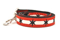 Large dog leash has two outer red stripes and one central off-white stripe and black six point stars around the collar. 