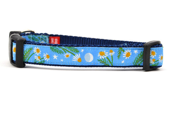 Small light blue dog collar with chamomile flowers, stars, and half moon design.