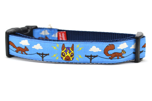 Medium light blue dog collar - design includes squirrels running on telephone wires and squirrel in lucha libre mask.  The mask is purple and yellow with electrical sparks coming from the mask.