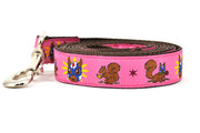 One large pink dog leash - design includes squirrel in lucha libre mask with a yellow flower behind it and a tulip on the mask.  One small squirrel with a tulip in its mouth and one with a tulip bulb.  Also, a six pointed star.