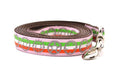 Large pink dog leash with light green, white, and red stripe stripe and gray bicycyle sprockets.