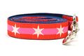 Large dog leash with 2 outer red stripes and 1 pink stripe in the middle and white six pointed stars around the collar.