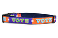 Large dog collar that is purple and orange blocks pattern with the word VOTE on each color block. 