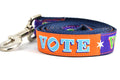 Large dog leash that is purple and orange blocks pattern with the word VOTE on each color block.