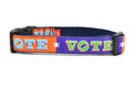 Medium dog collar that is purple and orange blocks pattern with the word VOTE on each color block. 