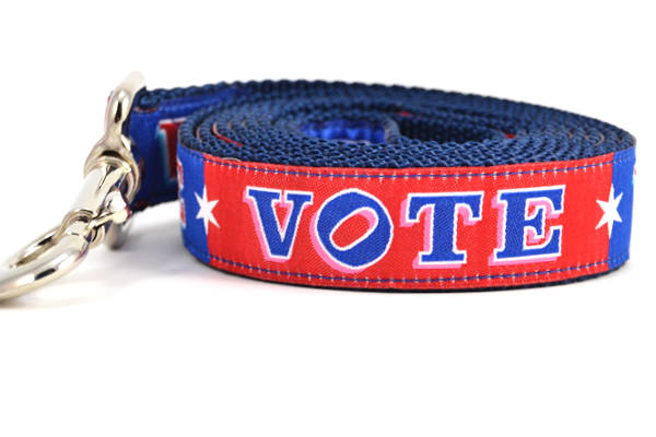 Large dog leash that is red and navy blocks pattern with the word VOTE on each color block. 