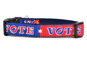 Medium dog collar that is red and navy blocks pattern with the word VOTE on each color block. 