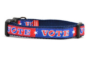 Small dog collar that is red and navy blocks pattern with the word VOTE on each color block. 