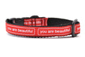 XXS dog collar that is red with the words you are beautiful in white. 